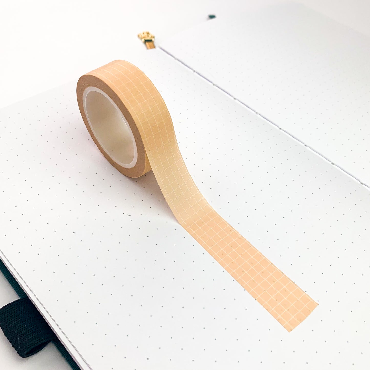 Peach grid washi tape roll laid out